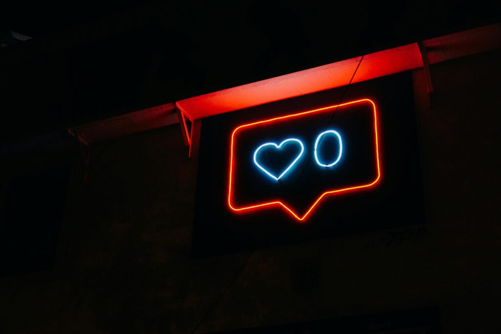 10 Proven Ways to Get More Likes on Social Media Bright neon heart icon with zero likes, symbolizing social media engagement.